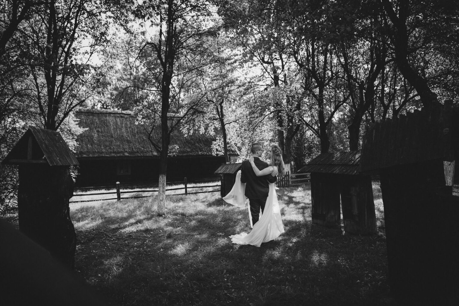 Panna młoda noszona na rękach w ogrodzie skansenu w Opolu